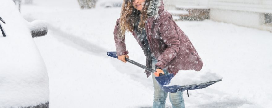 woman shoveling snow