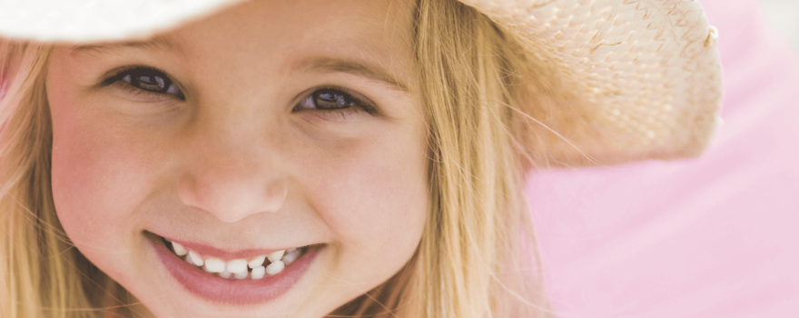 smiling girl in woven hat