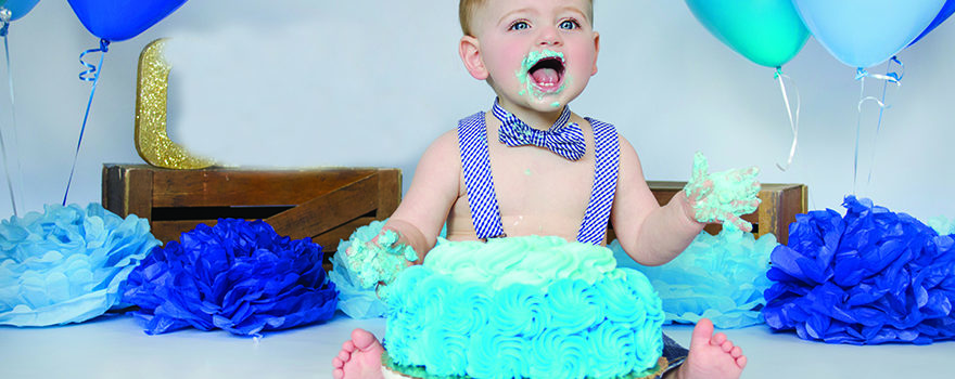 toddler eating cake with his hands