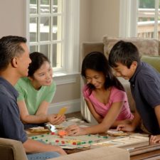 family playing monopoly