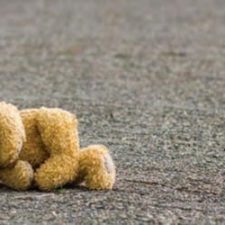 teddy bear abandoned in road
