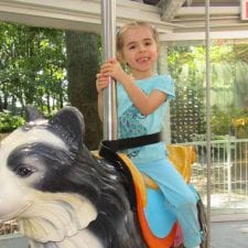 girl riding carousel
