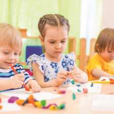 focused kids doing crafts