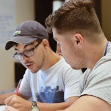 man providing help to other man