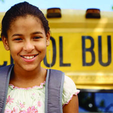 smiling girl at school bus
