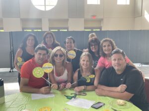 People at a table who participated in a pickleball tournament