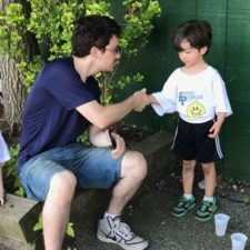 man shaking hands with young boy