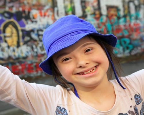 special needs girl in purple hat