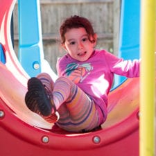 girl in playground structure