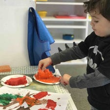 boy in batman shirt making art
