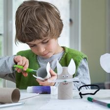 kid making paper animals