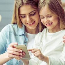 mom and daughter use iphone