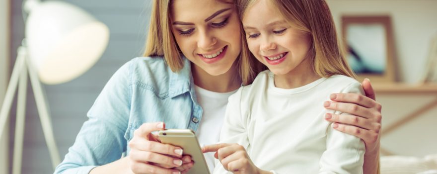 mom and daughter use iphone