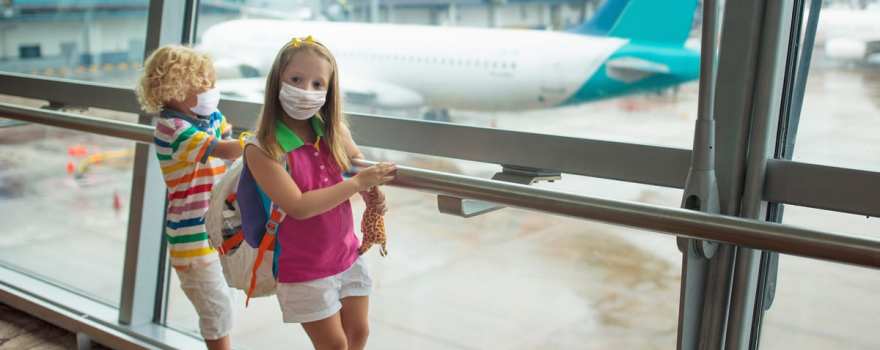 Kids in masks at airport