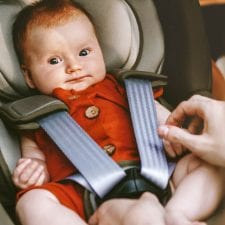 red headed baby in car seat