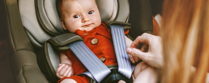 red headed baby in car seat