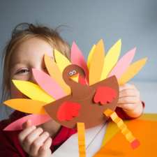 Girl holding turkey craft
