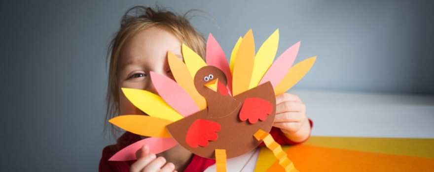 Girl holding turkey craft