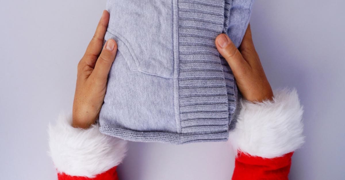 santa hands hold sweater for coat drive