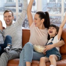 excited family on the couch