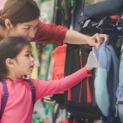 mother and child shopping for a backpack