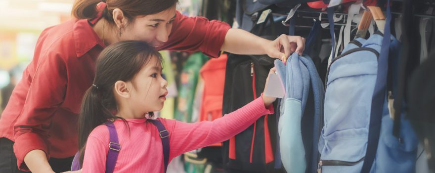 mother and child shopping for a backpack