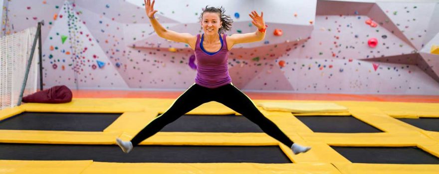 teen girl jumping at indoor trampoline park