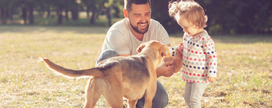 Father and child walking dog