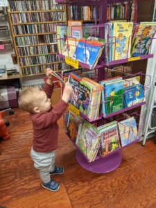 a boy toddler browsing books