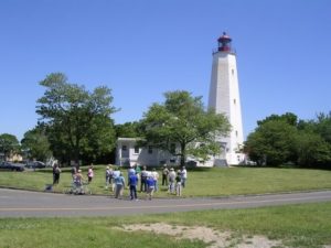 people visiting a lighthouse on a clear day