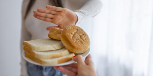 teen avoiding a plate of bread
