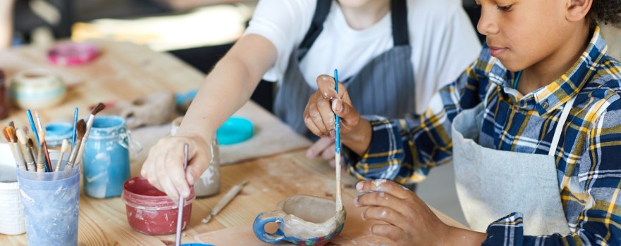 two children painting at a table
