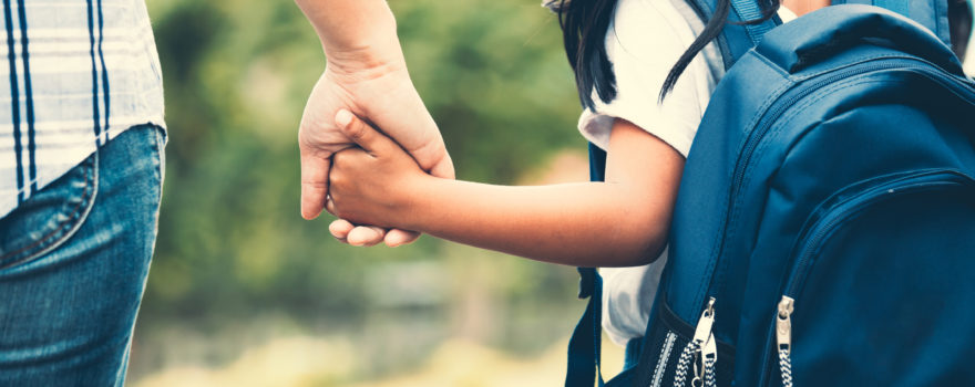 parent and young child holding hands