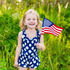 little girl holding an American flag
