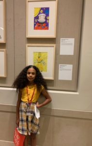 young student next to her drawing of mae c. jemison