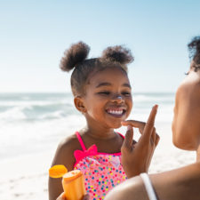 little girl with mother at the beach