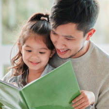 father and daughter reading to improve reading skills