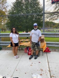 food pantry founder with a volunteer outside