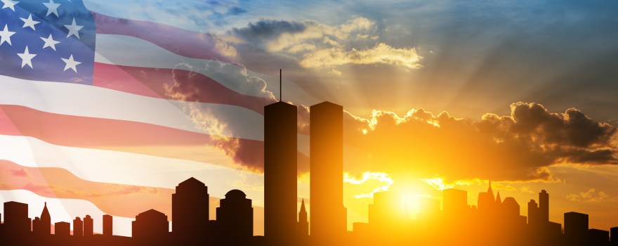 The World Trade Center in NYC with American flag in the background. This appears in an article about talking to kids about September 11.