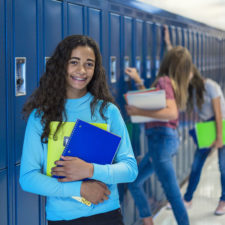 teen at lockers in a school