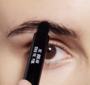 An eye with brow pencil.