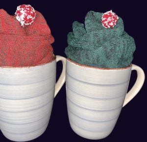 Mugs with festive socks inside as gift.