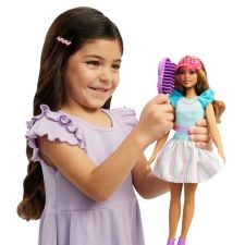 Little girl playing with Barbie doll for preschoolers.