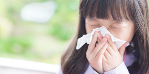 Little girl sneezing.