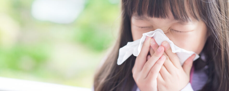 Little girl sneezing.