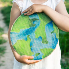 Child holding a globe.