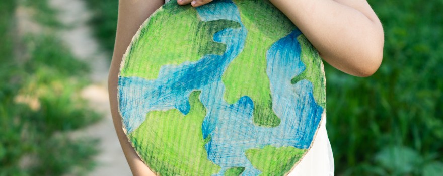 Child holding a globe.
