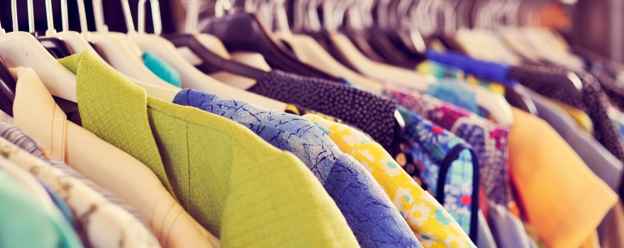 Clothes hanging on a rack at a market, similar to what can be found at an artists market on Staten Island