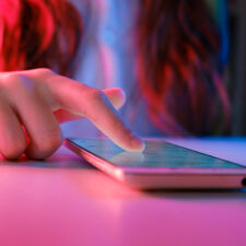 close up of a teenage girl's hand on a smartphone, a device where kids can learn about dangerous TikTok challenges