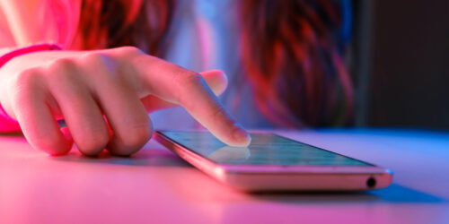 close up of a teenage girl's hand on a smartphone, a device where kids can learn about dangerous TikTok challenges